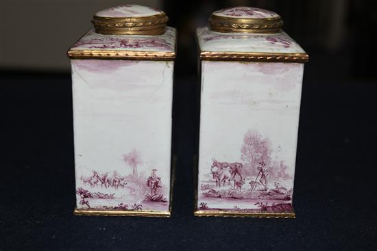 A pair of South Staffordshire enamel tea caddies and covers, and two similar candlesticks, late 18th century, 6.25in. and 10in., candle